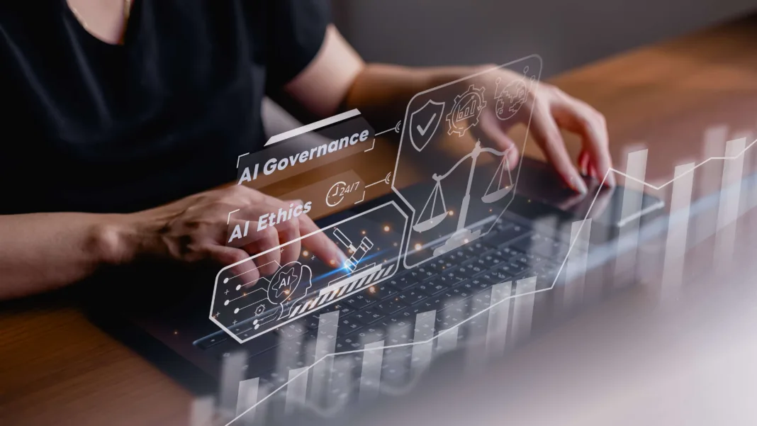 person sat at a desk with a keyboard at their fingertips. Images and words appear above the keyboard saying AI Governance - they appear as if they are floating above the keyboard
